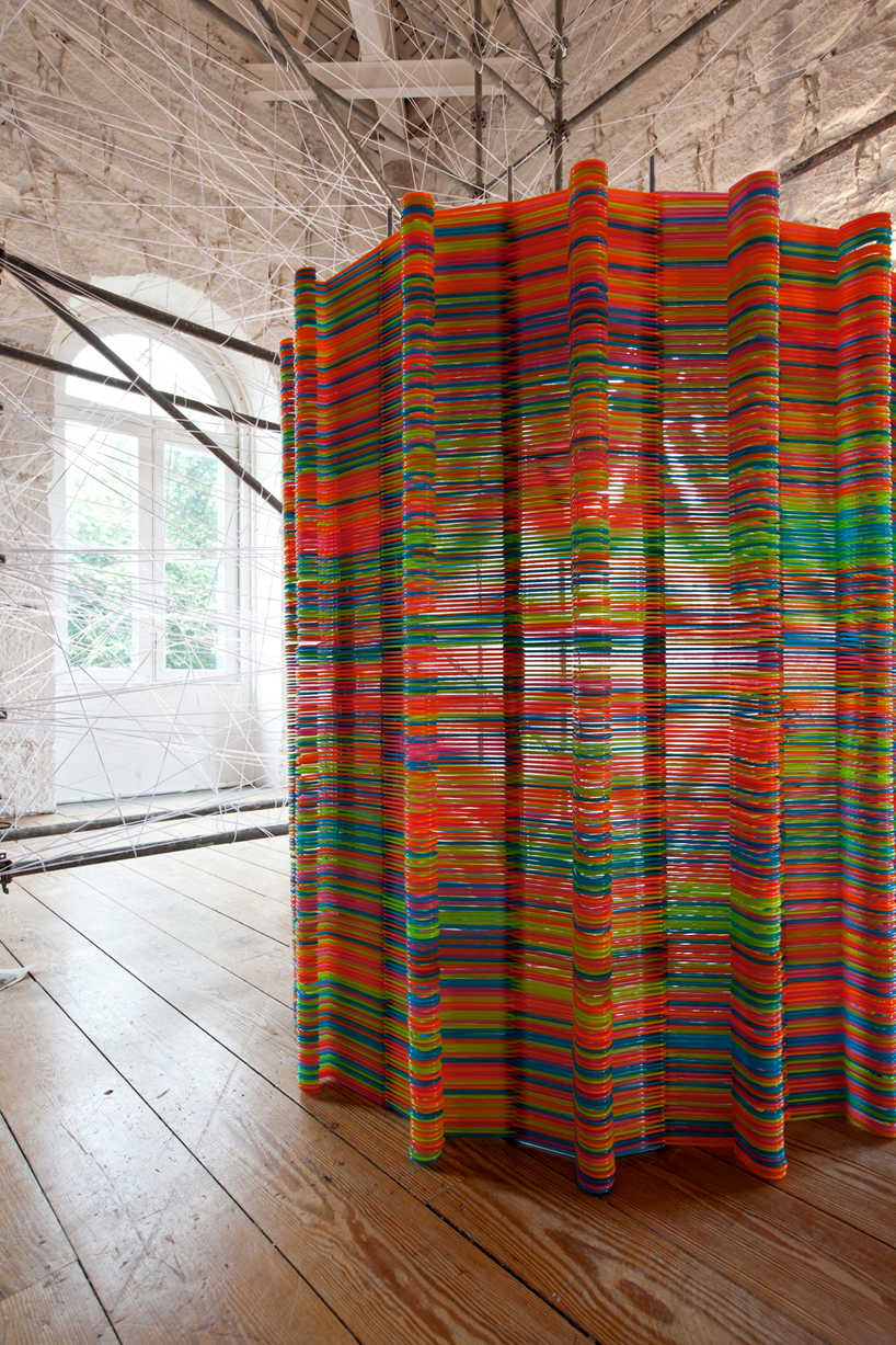 LIKEarchitects form chromatic screen installation with IKEA hangers